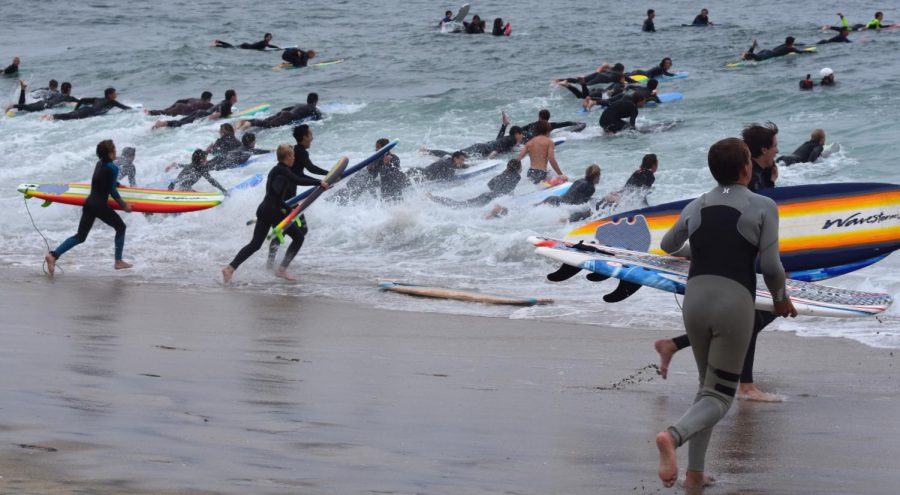 Surfers rush into the water to begin the event. The event was thrown by PTC, a group of local surfers who enjoy to create events such as the Tamarack Takeover.