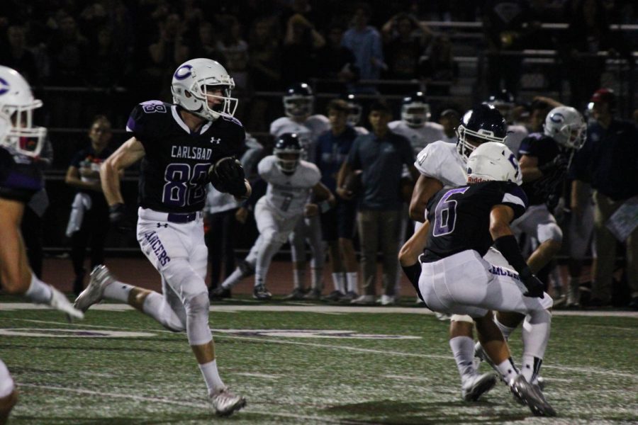 Sophomore Josh Davis intercepts the ball from San Marcos and runs it up the field. The Lancers won 28-7 in the home game to improve to 4-1 on the season.