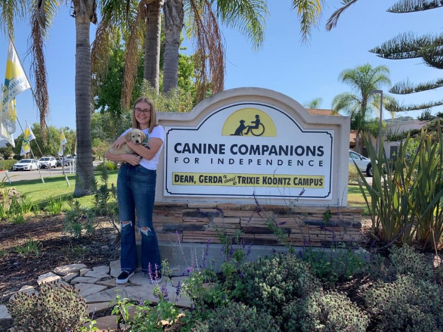 Hansen poses with her dog, Isley, in front of CCI premises.