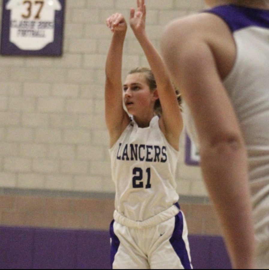 Freshman, Madison Huhn shoots the ball. The girls basketball season has just recently started up in early December.