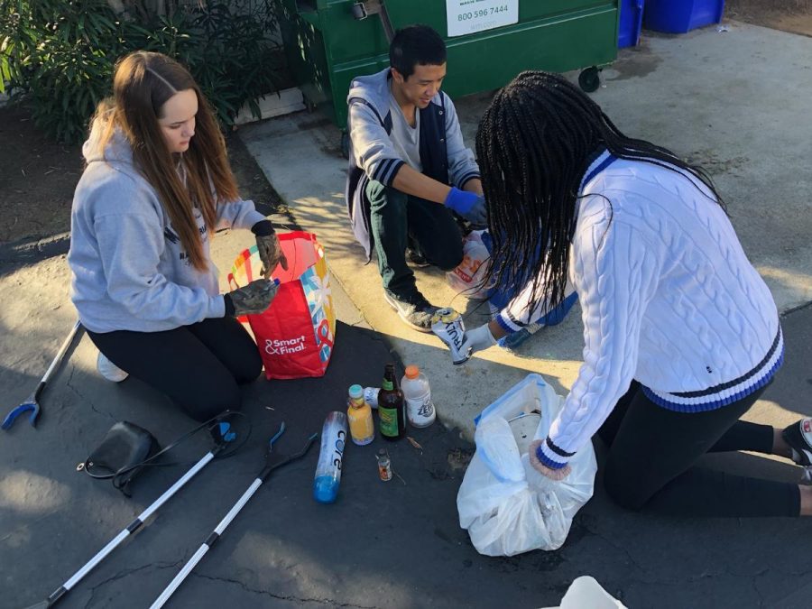 Lu and club members sort out recyclables from trash after spending an hour of cleaning litter around Carlsbad.