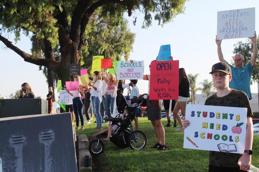 A+CUSD+student+carries+a+poster+with+the+slogan+Students+need+schools+as+part+of+a+rally+to+reopen+schools+outside+the+district+office+on+Wednesday%2C+Sept.+23.+Photo+by+Lena+McEachern.
