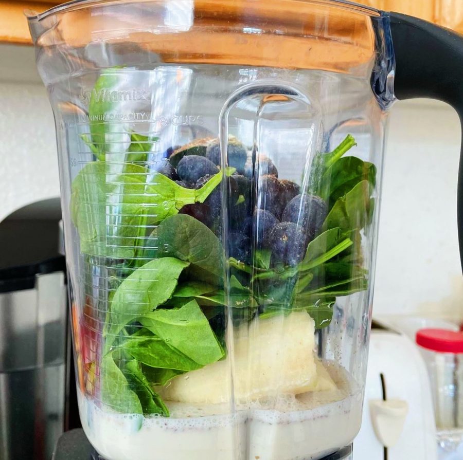 Green smoothie made with spinach, bananas, and blueberries. Smoothies are a vital part of any plant based diet. 
