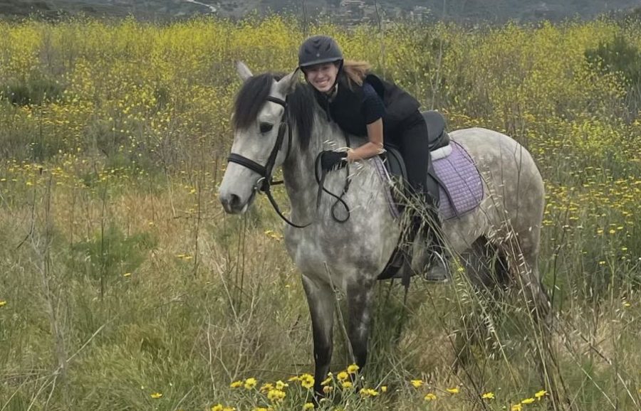 Avery Briones riding her project horse on a trail ride.