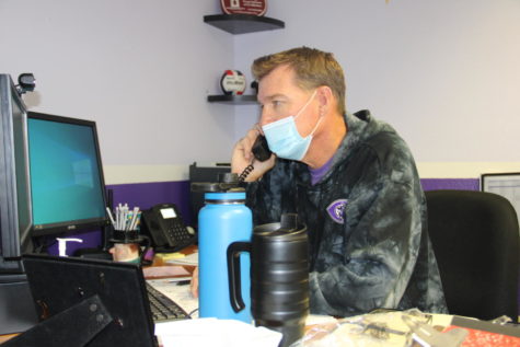 Athletic director Tom Bloomquist works in his office during the day and coaches womens volleyball in the afternoons.