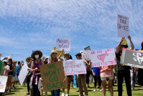 Protesters against the Supreme Courts draft to overturn Roe vs. Wade gathered at the corner of Carlsbad Blvd and Pine Ave on May 14, 2022. Receiving both cheers and boos from passing cars, the protesters chanted Roe wont go and My body, my choice.