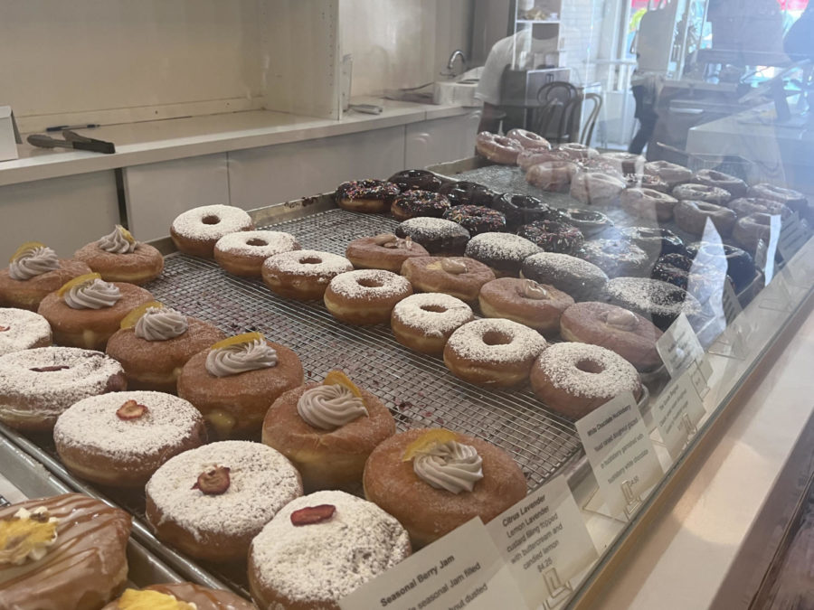 The Goods freshly-made donuts line the counter as customers walk into the shop. The shop features both seasonal and regular flavors.