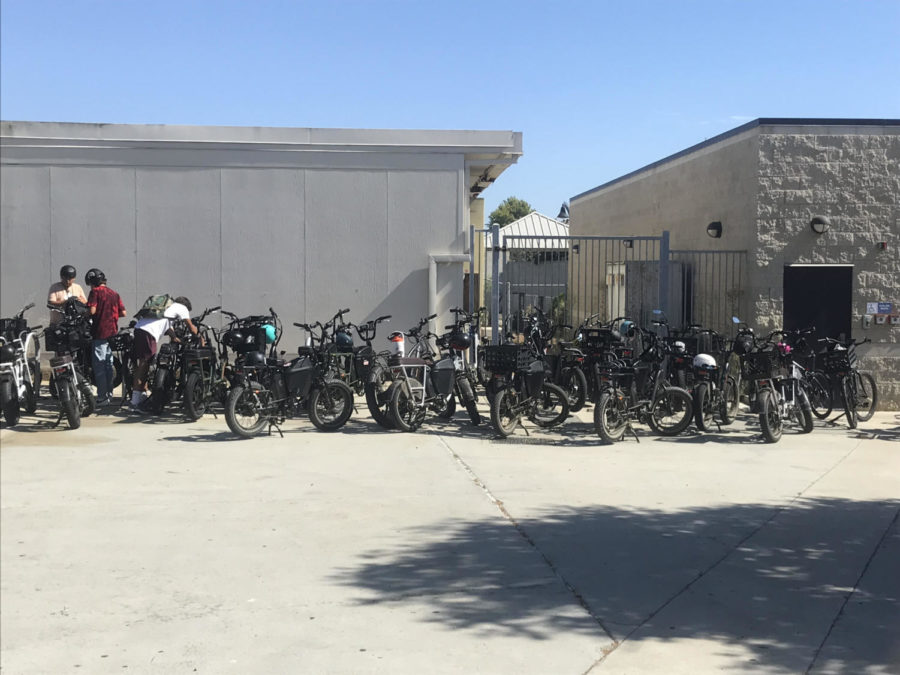 Students pick up their e-bikes behind the 3000s building at the end of the school day. This part of the school, once an open area, has become an unofficial parking lot for e-bikes.