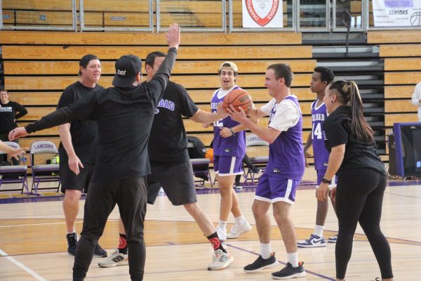 The Special Olympics basketball team plays against CHS staff at a home game.