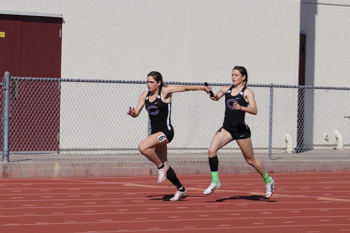 Makenna hands off the baton to Morgan in the last leg of the 4x1.