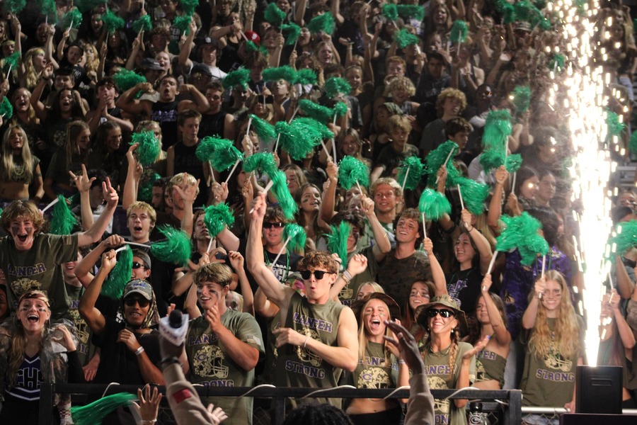 Senior Torin Campbell (front center) and the rest of The Loud Crowd cheer for the football team during the Camo Game on Sept. 13.