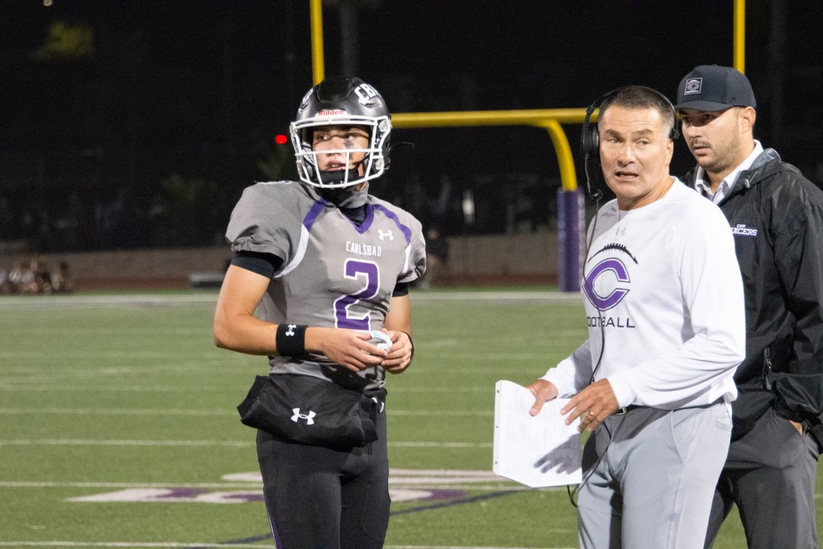 Coach Thadd MacNeal and junior Eli MacNeal at the homecoming game Oct. 4.