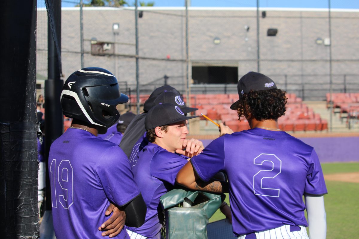 Lancer varsity baseball discussing plays during a break in the inning. 