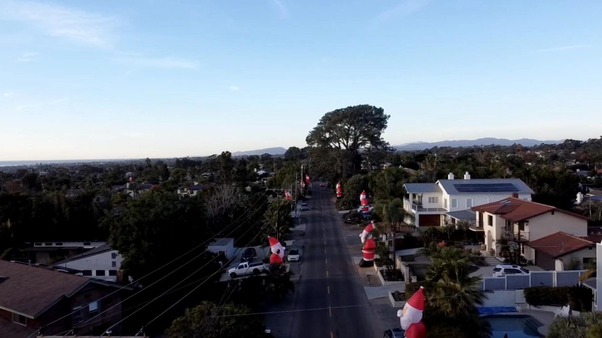 Giant inflatable Santas line the streets of Highland Drive and Chestnut Avenue. 