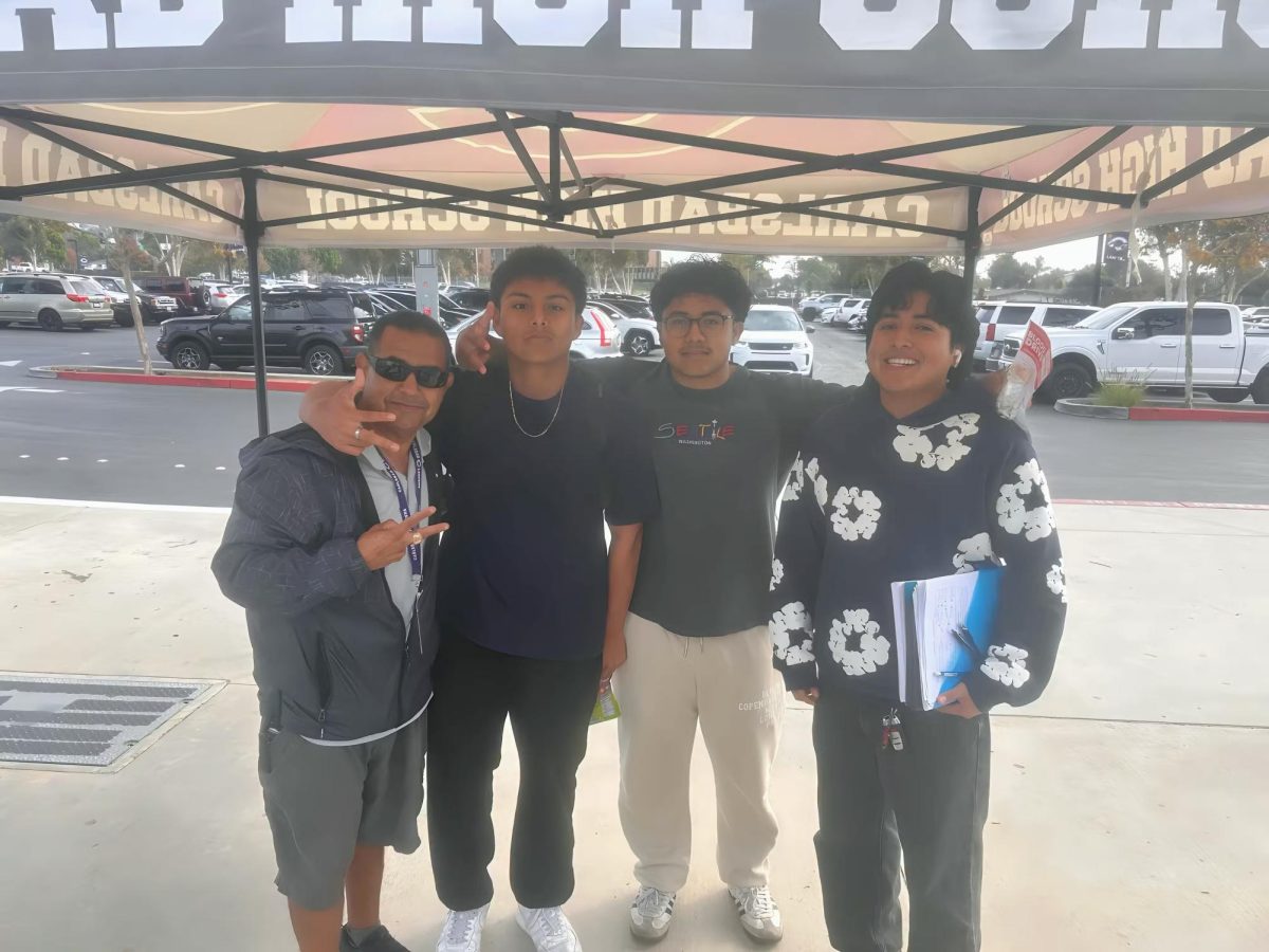 During school hours, Roger Casanova (far left) talks and hangs out with students.