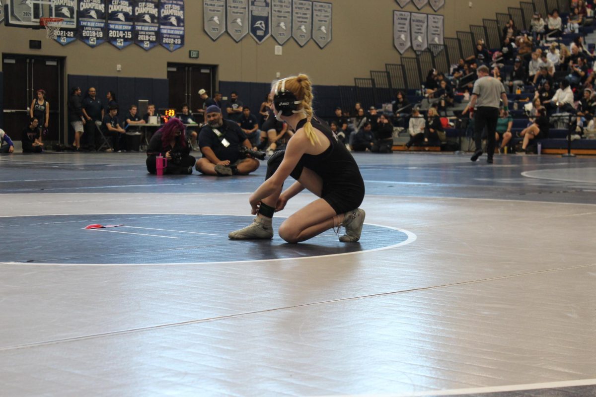 Sarah Stark preparing for her match at the Queen of the Realm tournament at San Marcos High School 
