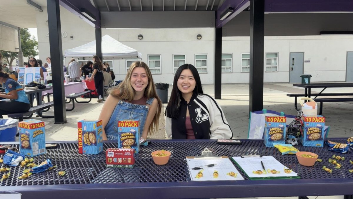 Club members Chloe Stevens (left) and Lexie Han (right) at a meeting. 
