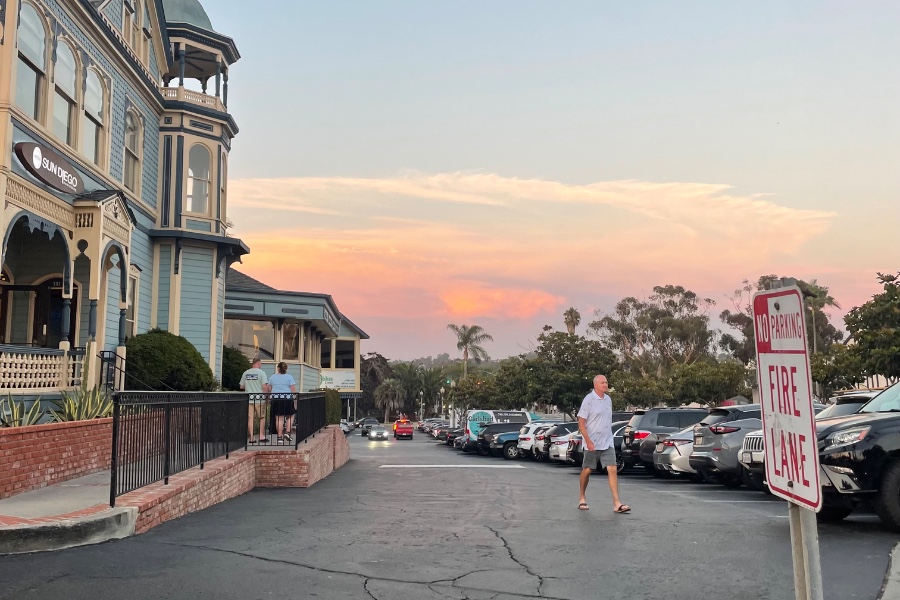 Pedestrians walking into the parking lots due to a lack of designated pedestrian areas, specifically around the Village Faire Restaurant & Shops.