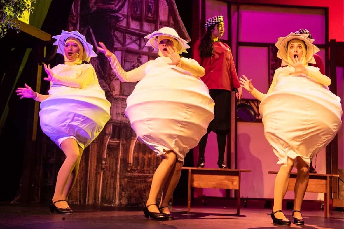 Performers sing and dance during the Omelette scene of Something Rotten
