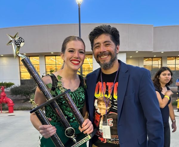 Mary Kate Henriod holding the first place trophy for Oceanside Sound-Off intermediate treble with her choir director Eloy Castaneda.